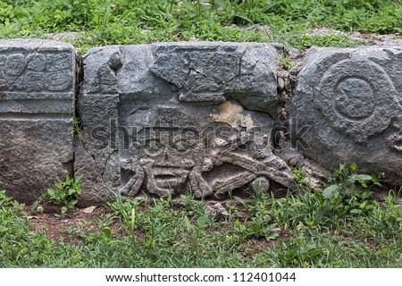 Images of the skull and bones on the rocks at the square of the Palace of Death in Uxmal - Yucatan, Mexico