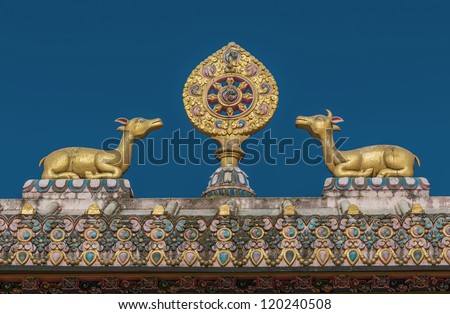 The sculpture of the wheel of Dharma and two deer on the roof of the gate of the monastery Tengboche - Nepal