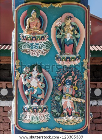 Bas-relief image of Buddhist gods on the columns of the main gate of the Tengboche monastery - Nepal