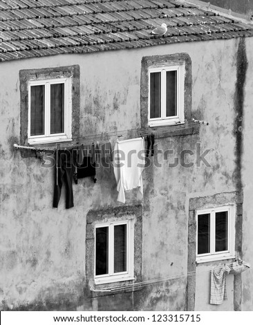The house drying clothes on a small street  in the old quarter of Ribeira - Porto, Portugal (black and white)