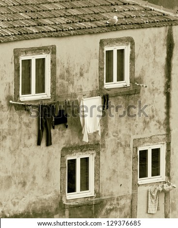 The house drying clothes on a small street  in the old quarter of Ribeira - Porto, Portugal (stylized retro)