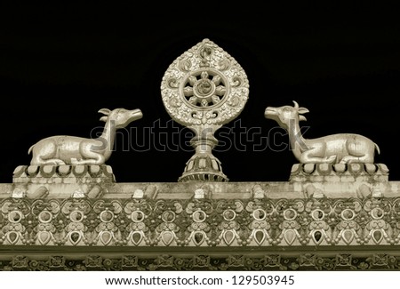 The sculpture of the wheel of Dharma and two deer on the roof of the gate of the Tengboche monastery - Nepal, Himalayas (stylized retro)