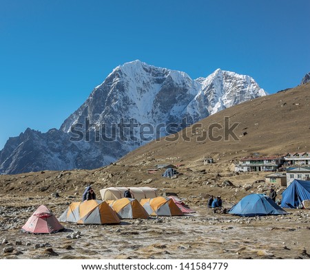 Tourist tents on the trek at the foot of mount Everest (8848 m) near Lobuche village - Nepal, Himalayas