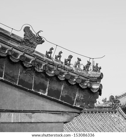 Architectural fragments of palaces in the Forbidden City in Beijing during smog, China (black and white)