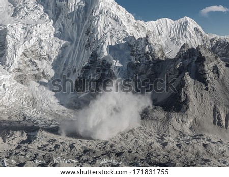 Snow avalanche falls from the slope of the Nuptse (7864 m), view from Kala Patthar - Nepal, Himalayas