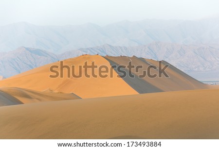 Tourists travel through the dunes in the Atacama Desert - Oasis of Huacachina, Peru, South America