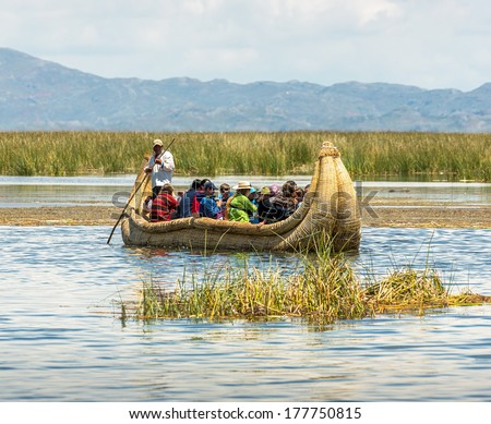 TITICACA, PERU - JAN 03, 2014: Traditional reed boat for touristic excursion. Reed floating island Uros. The Qhichwa Uros are a pre-Incan people who live on 42 self-fashioned floating islands
