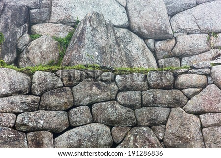 IWall in Inca city Machu Picchu at mist weather. It is a designated UNESCO World Heritage Site - Peru, South America