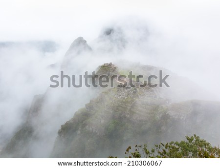 Inca city Machu Picchu in mist weather. It is a designated UNESCO World Heritage Site - Peru, South America