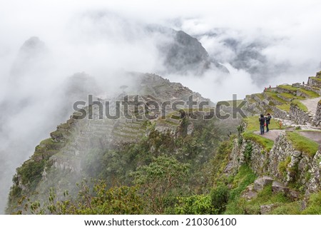 Inca city Machu Picchu in mist weather. It is a designated UNESCO World Heritage Site - Peru, South America
