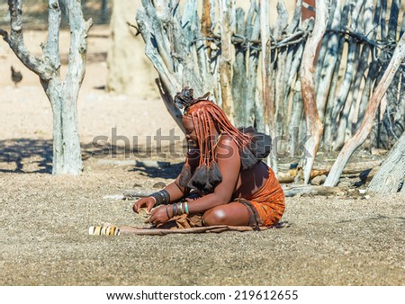 FRANSFONTEIN, NAMIBIA - JULY 09, 2014: A young woman Himba tribe. The Himba are indigenous peoples living in northern Namibia, in the Kunene region of South-West Africa