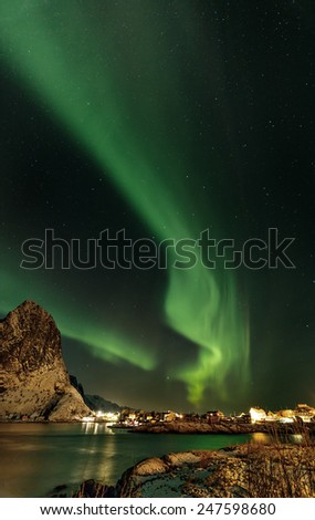 Aurora borealis (Polar lights) over the mountains in the North of Europe - Reine, Lofoten islands, Norway