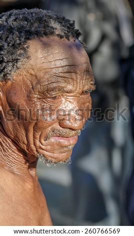 BUITEROS, NAMIBIA - JULY 17, 2014: Close-up portrait hunter Bushman. The San people, also known as Bushmen are members of various indigenous hunter-gatherer peoples of Southern Africa