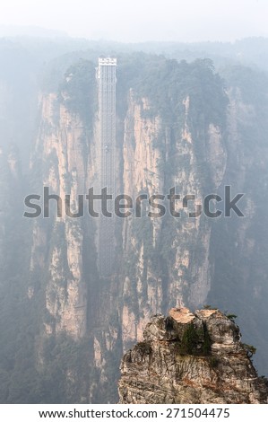 Rock columns mountain (Avatar rocks). Unique travel lift in the background. Zhangjiajie National Forest Park was officially recognized as a UNESCO World Heritage Site - China