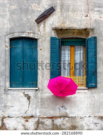 Beautiful window and umbrella on the ancient wall - Venice, Italy