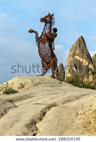 GOREME, TURKEY - JULY 15, 2015: Modern sculpture stands on the grounds of a horse farm. Cappadocia is a UNESCO World Heritage Site since 1985, Turkey