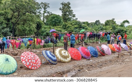 JAMMU AND KASHMIR, INDIA - 08 AUGUST, 2015: Locals sell umbrellas near the road during heavy rains - Jammu and Kashmir, India. Tibet