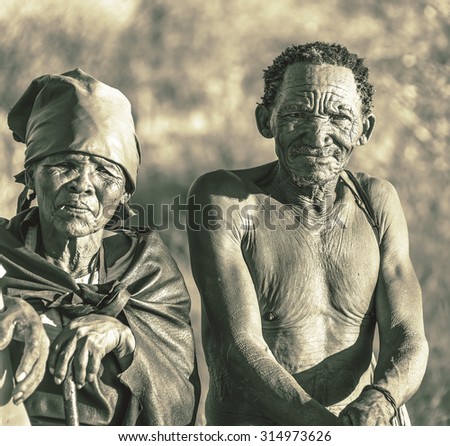 BUITEROS, NAMIBIA - JULY 17, 2014: Hunter Bushmen and their wives posing tourists. The Bushmens are members of various indigenous hunter-gatherer peoples of Southern Africa (stylized retro)