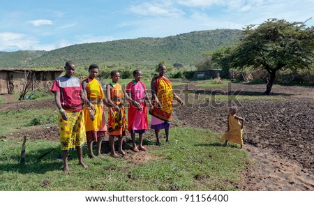 MASAI MARA, KENYA - DECEMBER 2: Masai warriors dancing traditional jumps as cultural ceremony. As well as their women sing and dance. Masai Mara National Park, December 2, 2011 in Kenya