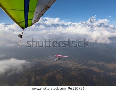 The motor hang-gliding in the sky near the himalayan peaks of the Annapurna region - Nepal
