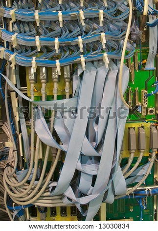 Computer cables and circuit boards in control cabinet.