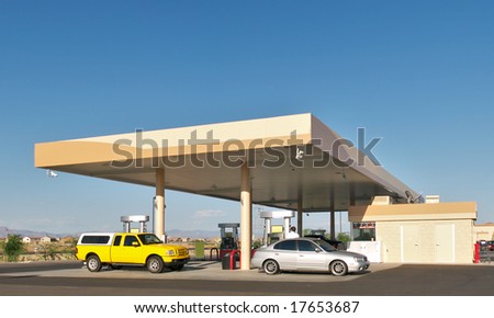 Cars filling up at gas station.