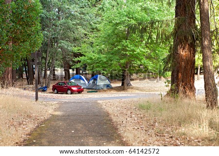 Camping place with tents and car.