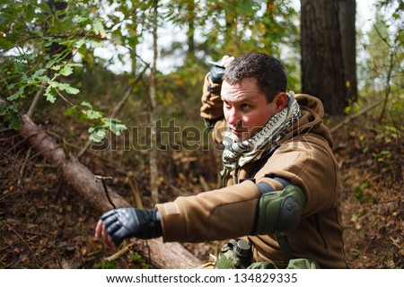 Terrorist at forest throwing knife.