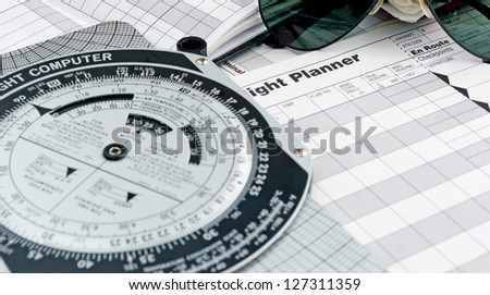 pilot style sunglasses on a flight plan paper