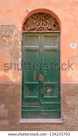 green old door, in an orange wall