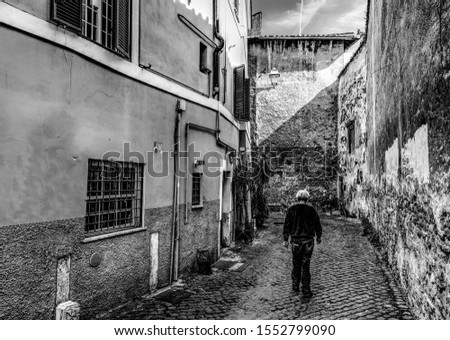 Old man in a narrow street in Italy. Black and white effect Zdjęcia stock © 