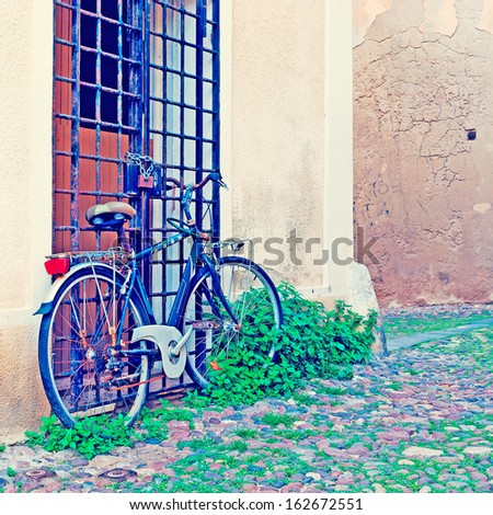 old bike in Alghero old town in vintage tone