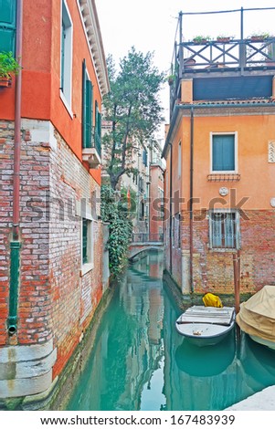 narrow Venice canal with boats