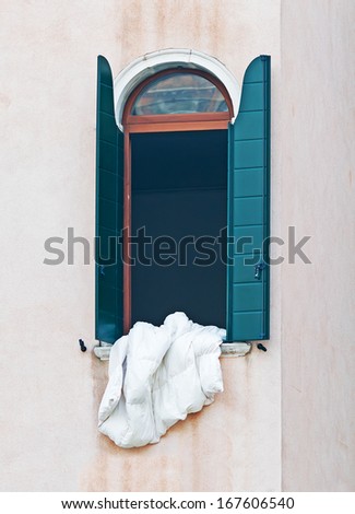 white blanket in an open window