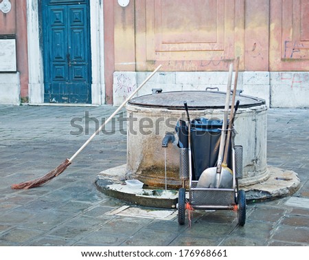 street cleaner broom leaned against a well in Venice, Italy