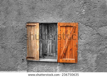 wooden window in a rustic wall. Processed for selective desaturation effect.