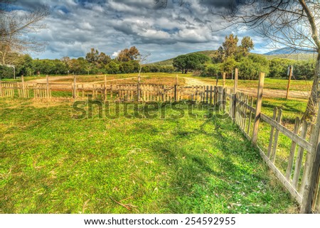 wooden fence in a green field. Processed for hdr tone mapping effect.