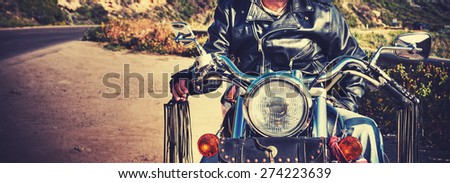 biker on a classic motorcycle in vintage tone effect