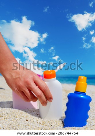 girl holding a suntan lotion bottle