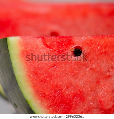 close up of a watermelon slice with black seed