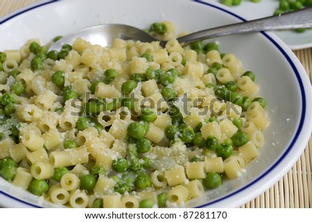 pasta with peas and cheese on a bamboo placemat