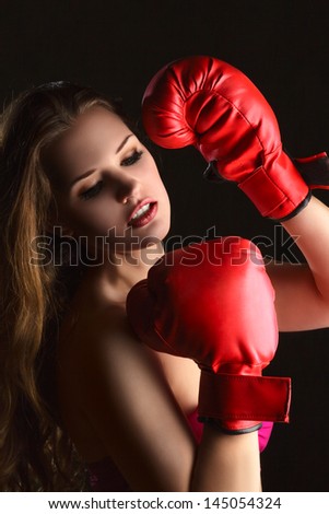 Young blonde woman with boxing gloves isolated on white background