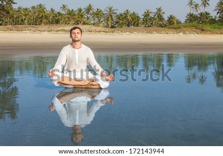 Man doing yoga asana meditating in a lotus position