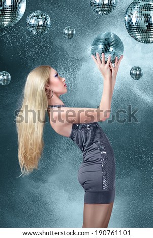 Young blonde woman dancing at night disco club