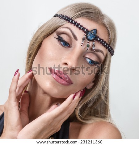 Young fashion woman posing with hands on face