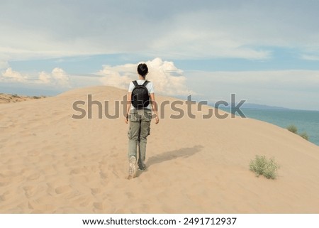 Similar – Image, Stock Photo Lone female hiker contemplating the clouds from the top of a mountain