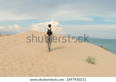 Similar – Image, Stock Photo Lone female hiker contemplating the clouds from the top of a mountain