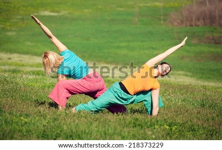 Young women practicing yoga in nature. Sun warrior.