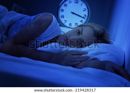 Woman awake early in the morning, having insomnia.