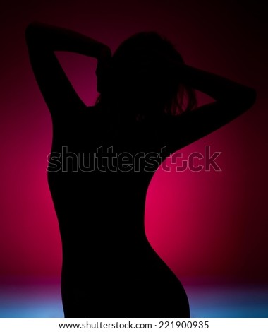 Female silhouette dancing in the dark - pink, blue background.